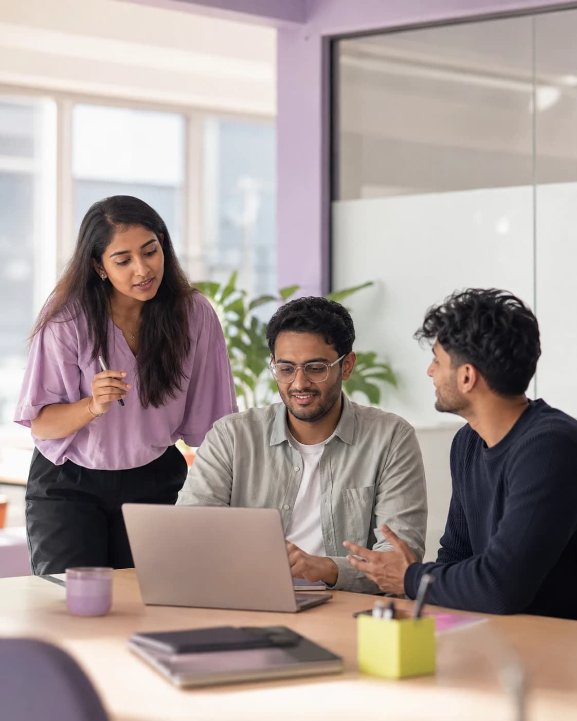 Dashrathi team members collaborating around a laptop